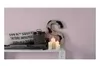 Decorative items on a shelf, including candles, a large letter 'S', and a sack with text. Produktbild-Vorschau