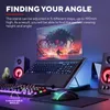 A laptop stand with a laptop, keyboard, and mouse on a desk, with speakers in the background. Produktbild-Vorschau