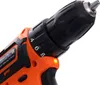 Close-up view of the chuck and torque adjustment ring of an orange and black cordless drill. Anteprima dell’immagine prodotto