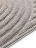 A close-up view of a gray rug with a textured chevron pattern. Anteprima dell’immagine prodotto