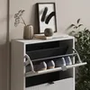 A white shoe cabinet with three flip-down drawers, displaying two pairs of shoes in the open bottom drawer. Produktbild-Vorschau