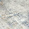 A close-up view of a textured rug with an abstract pattern. Produktbild-Vorschau