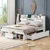 A white bed with storage drawers and a headboard with shelves is shown in a bedroom setting. Anteprima dell’immagine prodotto