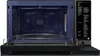 An open microwave oven with a glass turntable inside. Voir les images du produit