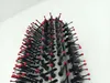 A close-up view of the bristles and head of a round hairbrush. Voir les images du produit