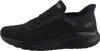 A side view of a black Skechers slip-on sneaker. Voir les images du produit