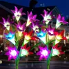 Solar powered LED flower lights illuminating a garden at night. Anteprima dell’immagine prodotto