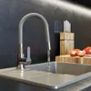 A kitchen sink with a faucet running water, and some tomatoes and a knife block in the background. Anteprima dell’immagine prodotto