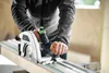 A person is using a Festool track saw to cut a piece of wood. Podgląd zdjęcia produktu