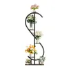 A multi-tiered plant stand with various floral arrangements on each shelf, set against a white background. Anteprima dell’immagine prodotto