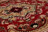 A close-up view of a red oriental rug with intricate patterns in tan, black, and white. Anteprima dell’immagine prodotto