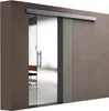 A modern glass sliding door with a brushed metal handle, installed in a contemporary interior with a textured brown wall. Produktbild-Vorschau