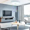 A modern living room with a TV, entertainment center, coffee table, and a ceiling light. Voir les images du produit