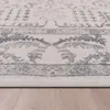 A close-up view of the edge of a rug on a wooden floor. Anteprima dell’immagine prodotto