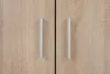 A close-up view of two cabinet doors with silver handles. Náhľad obrázku produktu