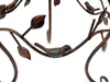 A close-up of a metal decorative bird on a branch, part of a plant stand. Produktbild-Vorschau