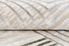 A close-up view of a rolled-up rug with a geometric pattern. Produktbild-Vorschau