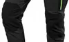 Close-up view of the lower part of two black pants, showing reinforced knee areas and a green zipper detail on one. Produktbild-Vorschau