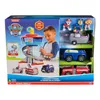 A child is playing with a Paw Patrol Lookout Tower and vehicles playset, which is displayed in its packaging. Produktbild-Vorschau