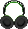 A pair of black and green headphones is shown from a top-down perspective against a white background. Produktbild-Vorschau