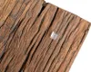 A close-up view of a wooden surface with a small, clear object on it. Produktbild-Vorschau