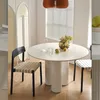 A round dining table with chairs in a well-lit room. Produktbild-Vorschau