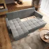 A modern living room with a grey sectional sofa, a fireplace, and a wooden coffee table. Produktbild-Vorschau