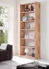 A wooden bookshelf filled with decorative items and books, placed in a living room setting next to a window and a sofa. Produktbild-Vorschau