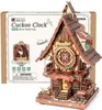 A 3D wooden cuckoo clock model kit and its packaging. Náhľad obrázku produktu
