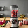 A hand is shown pressing a button on a Tefal blender filled with berries, with smoothies in jars in the foreground. Anteprima dell’immagine prodotto