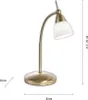 A brass desk lamp with a white glass shade is shown against a white background. Dimensions are indicated with measurement lines and text. Produktbild-Vorschau