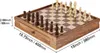 A wooden chess set with pieces arranged on the board, shown from a diagonal angle with dimensions indicated by text overlays. Náhled obrázku produktu