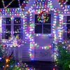 A house decorated with colorful string lights for a festive occasion. Voir les images du produit
