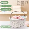 A laundry basket filled with clothes is shown on a shelf, with towels stacked behind it and a drawing of clothes on a clothesline on the wall. Produktbild-Vorschau