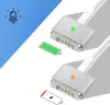 Two Macbook Magsafe 2 magnetic chargers are shown, one with a green LED indicating charging and the other with an orange LED indicating low battery. Icons for an LED and battery status are also present. Produktbild-Vorschau