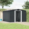 A dark gray metal shed with white trim is shown in a backyard setting, with a wooden deck in the foreground and grass and trees in the background. Náhled obrázku produktu