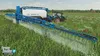 A tractor and sprayer in a field. Podgląd zdjęcia produktu
