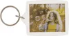A keychain with a photo frame showing a young girl blowing bubbles. Produktbild-Vorschau