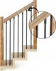 A close-up view of a wooden staircase railing with black metal balusters. Náhľad obrázku produktu