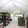 Interior view of a storage tent with shelves and a rolling cart. Produktbild-Vorschau