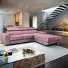 A pink sectional sofa in a modern living room with a staircase in the background. Produktbild-Vorschau