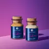 Two spice jars with cork stoppers on a purple and pink gradient background. Produktbild-Vorschau