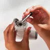 A person is inserting a battery into a device. Anteprima dell’immagine prodotto