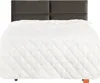 A bed with a white quilted comforter and a dark gray headboard. Produktbild-Vorschau