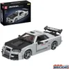 A model car kit of a Nissan Skyline GTR R34 is shown next to its packaging. Podgląd zdjęcia produktu