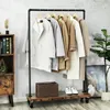 A stylish clothing rack with several coats on display, placed in a room with industrial-style decor. Náhled obrázku produktu