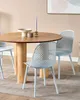 A dining set with a round wooden table and four light blue chairs. Náhled obrázku produktu