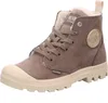 A single brown Palladium ankle boot with a cream-colored toe cap and sole, shown against a white background. Produktbild-Vorschau