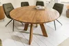 A round wooden dining table with four green chairs in a dining room setting. Produktbild-Vorschau