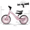 A pink balance bike with dimensions indicated by measurement lines and text. Náhľad obrázku produktu